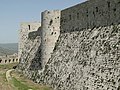 A rectangular and a round tower projecting from the wall at Krak des Chevaliers.