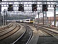 First Great Western (local) and Heathrow Connect trains pass on the approach of Paddington.