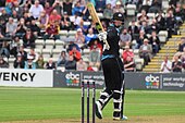 Tom Kohler-Cadmore raising his bat in the air