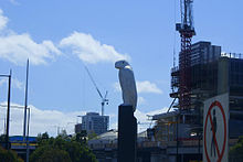 A large sculpture of an eagle with a roadway in front