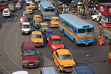 A road in Kolkata showing congested traffic and yellow taxis