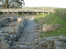 The ruins of a building. The remains of stone walls up to about 1-foot (0.3m) are all that remains.