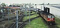 NSWR loco 44216 and another haul the northbound 'Brisbane Limited' across the Corinda line at Yeerongpilly, 1987