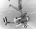 An F9C Sparrowhawk catches the trapeze aboard Macon in 1933