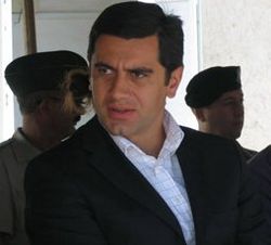 Headshot of Okruashvili in a suit gazing towards the left