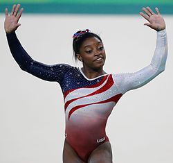 Biles smiling and waving