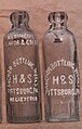 Anchor Bottling Works bottles with paint applied on the embossing