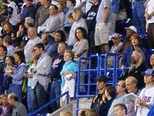 Crowd standing at the Metrodome, watching a Twins baseball game