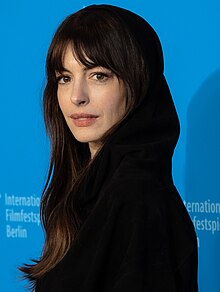 A head shot of Anne Hathaway as she poses for the camera