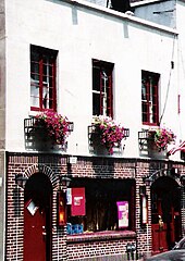 A color photograph of the Stonewall taken recently, showing a smaller plate glass window in a portion of the 1969 building