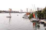 The river Nile flows through Cairo, here contrasting ancient customs of daily life with the modern city of today.