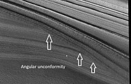 Close view of layers in northern ice cap, as seen by HiRISE under HiWish program Arrows point to an angular unconformity.