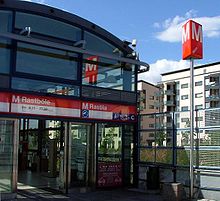 Top: M100 class en route to Vuosaari. M100 is the oldest metro class of Helsinki Metro. Bottom: Entrance to Rastila metro station in Vuosaari, Eastern Helsinki