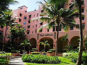 The Royal Hawaiian Hotel in Honolulu, Hawaii, built in 1927, was the first hotel on Waikiki Beach. Its pink color was designed to match an exotic setting, and to contrast with the blue of the sea and green of the landscape.