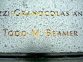 Closeup of Panel S-68, showing the name of Todd Beamer, after the pool's lights have been turned on, but before the sun has gone down.