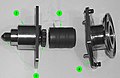 A partially-disassembled CBM Powered Bolt, showing both ends of the shaft (1), the lower housing (2) that nestles into the ACBM ring, the drive sleeve (3) and its spline interface with the shaft, and the upper housing (4). The upper housing and drive sleeve can be removed without demating the vestibule to install a spline lock under an IVA seal "butter dish". The spline lock prevents the bolt from backing out.[6][119]