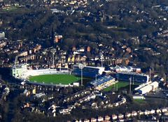 Two large stadia surrounded by terraced houses.