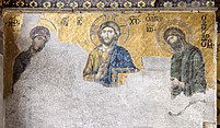 A mosaic painted golden yellow scraped off at the bottom. Three people with halos are depicted, the ones on the right and left are bowing towards the one on the centre. Greek letters can be seen, possibly labels describing the three people