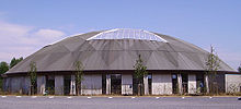 The structure has a round roof with a large skylight