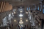 Underground hall from above, chandeliers and tourists