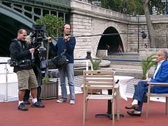 A one-man band boom operator/recordist holding a boom pole.