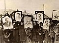 Image 44Russian peasants holding banners of Lenin (left), Marx (centre) and Trotsky (right) in early Soviet Russia. (from Russian Revolution)