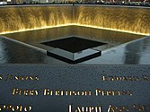 Nighttime shot of the North Pool, showing the name of Berry Berenson on panel N-76.