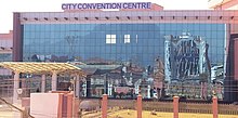 Rectangular pink building with glass front