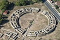 Aerial view of the ruins of a circular building made of stones