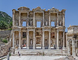 Reconstructed two-storey classical stone façade with four porticos and three entrances between them.