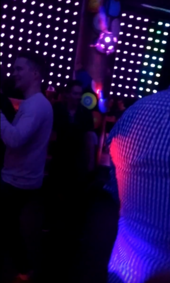 Crowded dance floor with neon lights