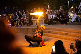 A performer closing out the day with a fire act.