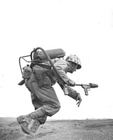 An American flamethrower operator runs under fire