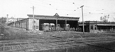 Streetcars in a single-story carhouse