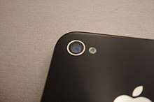 The camera on the back side of the iPhone 4S beside the iPhone 4 camera