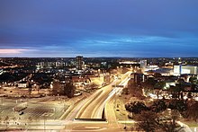 Night view of the road and slip roads with car headlights forming a continuous strip along the anticlockwise carriageway