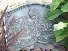 Close-up view of a plaque briefly describing the history of the adjacent road.