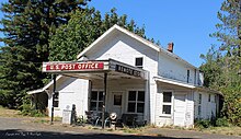 Remote, Coos County, Oregon off of present-day Highway 42. Photograph of the Post Office, Store, and gas station.