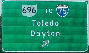 Button copy sign on US 30 in Ohio, showing reflection of buttons in letters, shield numerals and outline, and arrow