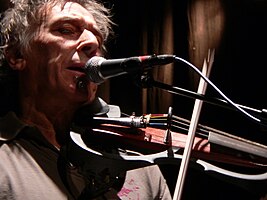 John Cale playing the electric viola at a concert in Belgium, 2006