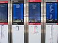 Vertical metallic standing screens, station concourse/entrance type. Photographed at Epping, an inner city suburban station.