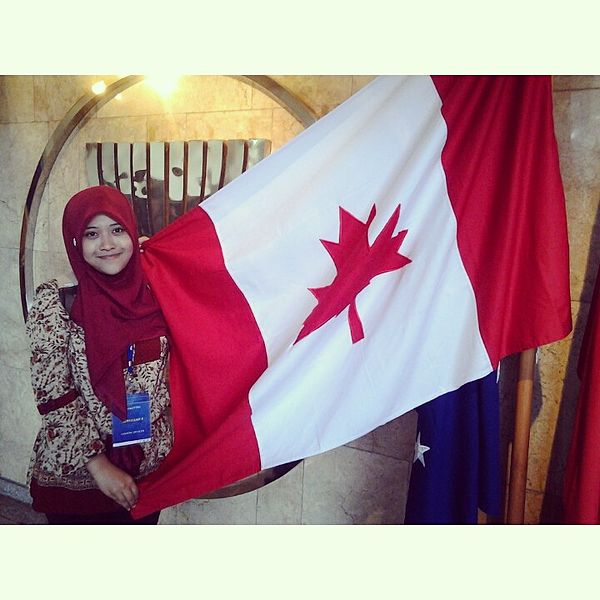 Fadhillah with the Flag of Canada in front of ASEAN Secretariat office