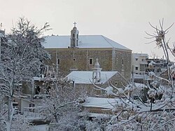 Ain Ebel in the winter, with Our Lady of Ain Ebel church in the background