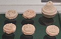 Five clay tsha-tsha and one miniature stupa model