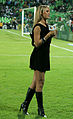 Sports anchor wearing little black dress and knee-high boots, Mexico, 2010.