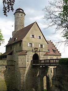 A castle with a bridge leading to it.