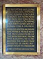 A plaque commemorating the Easter Rising at the GPO, with the Irish text in Gaelic script, and the English text in Latin script