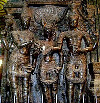 sculpture in temple column showing three figures