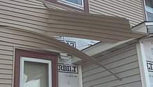 Damage to a home from a strong dust devil in IA, USA.