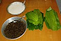 Parbolied (Ukadeñ tândul) rice paste, jaggery-coconut mixture (Chûn), and turmeric leaves (Hôldi pân)